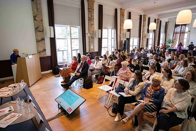 An overview of the conference room full of participants