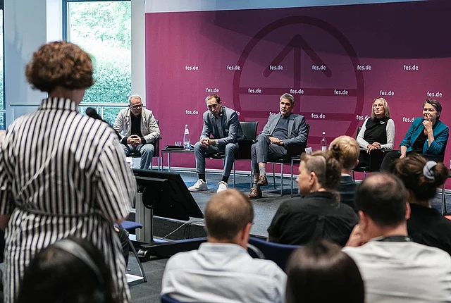 a participant asking questions to the panel